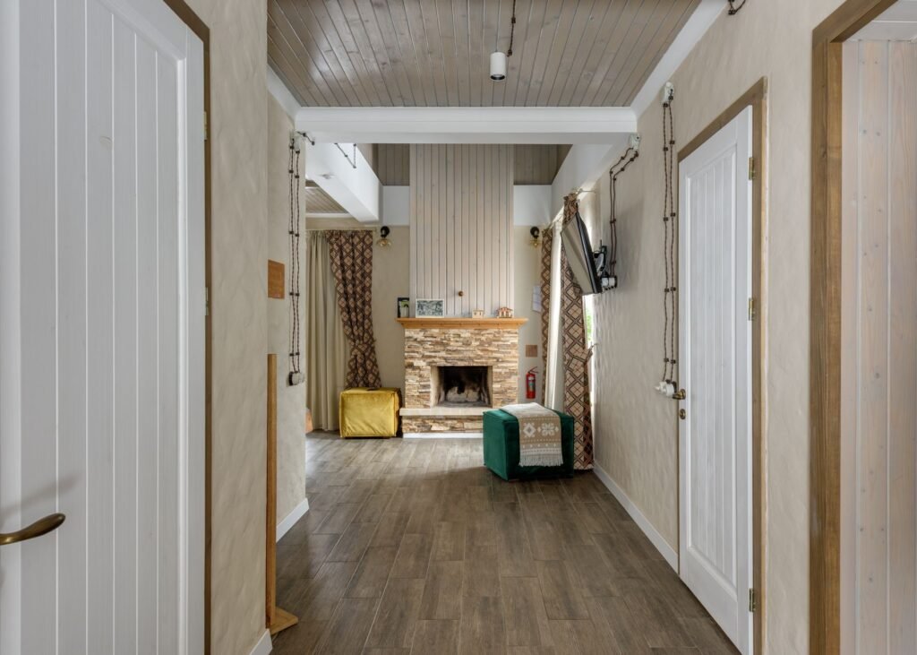 Warm and inviting chalet interior featuring wooden design and cozy fireplace setting.